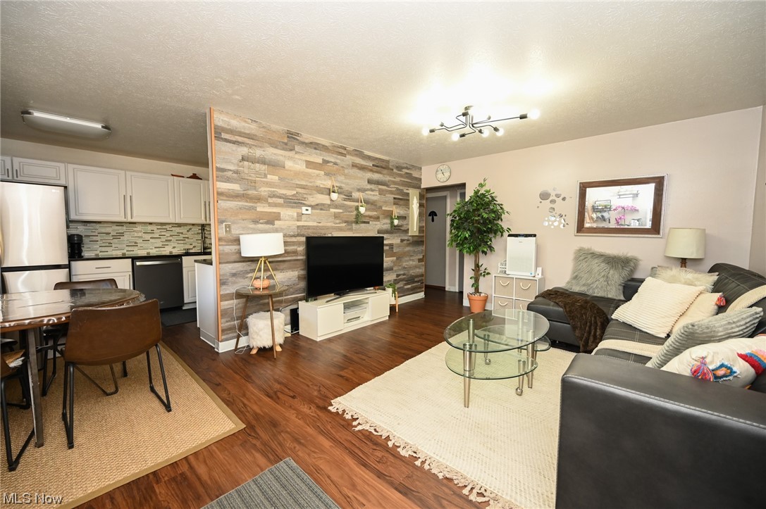 5651 Broadview Road, Unit C9 Cleveland, OH 44134 - Photo 3 of 29 Living room featuring dark wood-type flooring and a textured ceiling