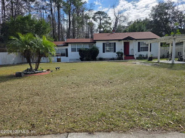 a front view of a house with a garden