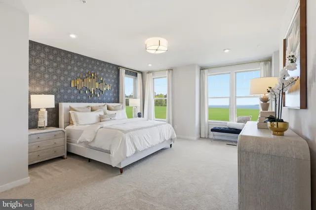 a spacious bedroom with a bed and a large window