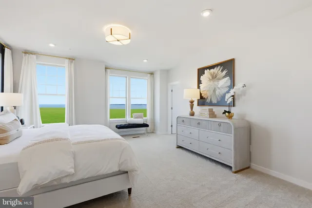 a spacious bedroom with a bed and a window