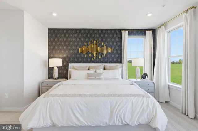 a bed sitting in a bedroom next to a window