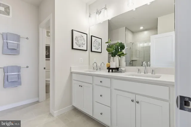a bathroom with double sink and a mirror