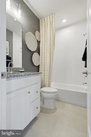 a bathroom with a double vanity sink toilet and shower