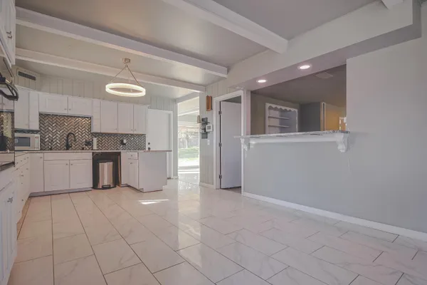 a large kitchen with cabinets and stainless steel appliances