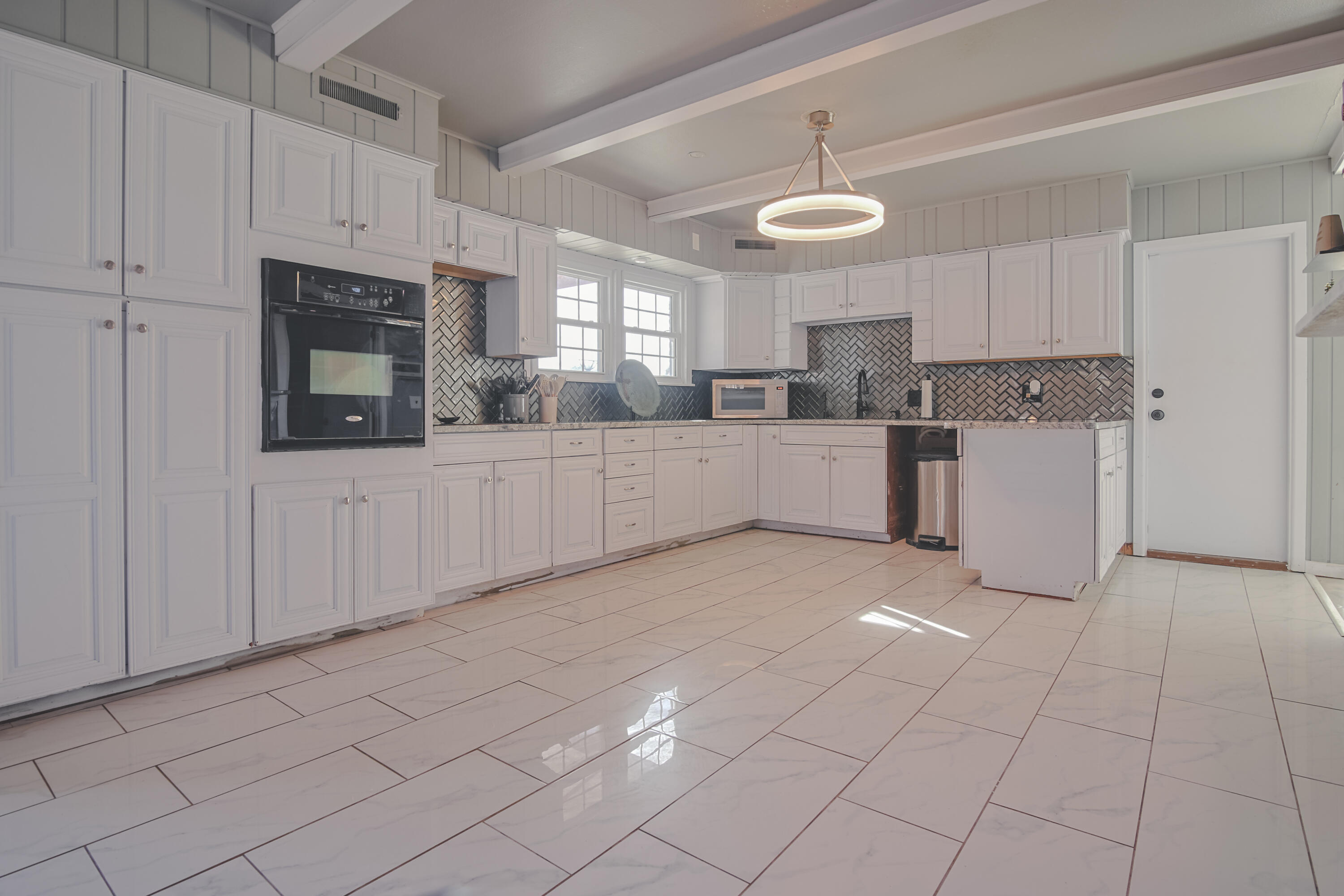 3407 Canyon Road Lubbock, TX 79403 - Photo 14 of 37 a large kitchen with cabinets and stainless steel appliances