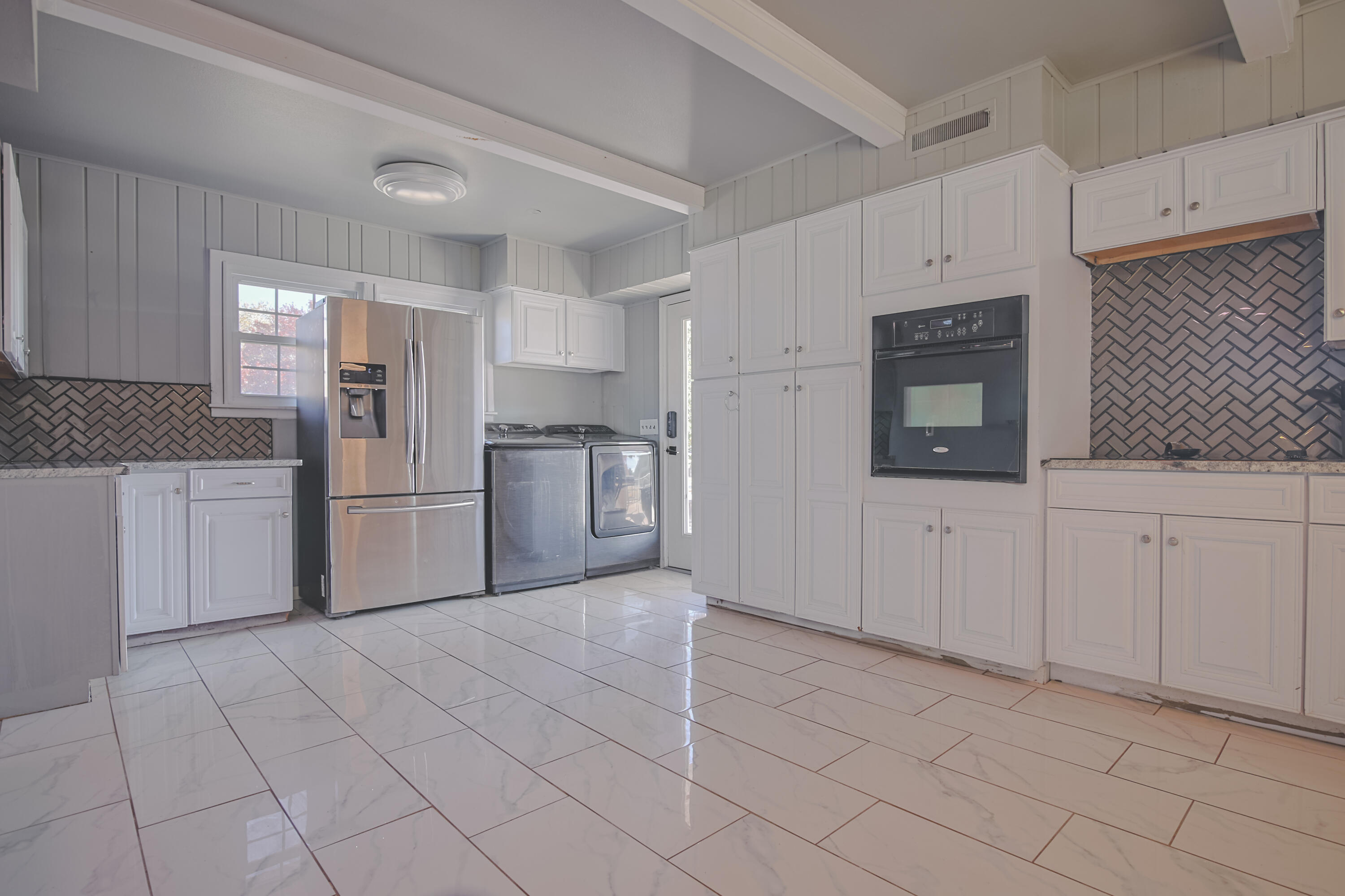 3407 Canyon Road Lubbock, TX 79403 - Photo 15 of 37 a kitchen with white cabinets and refrigerator