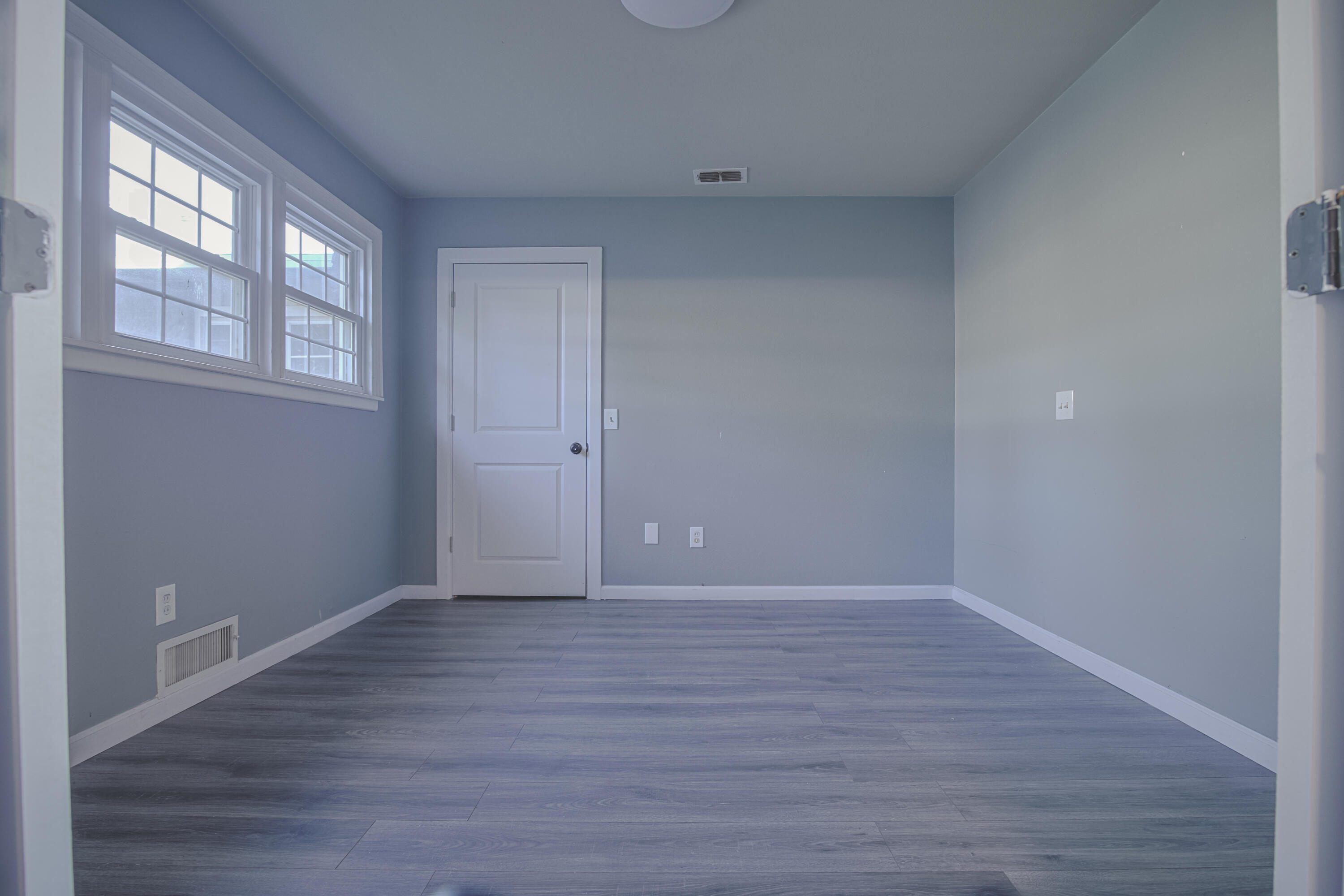 3407 Canyon Road Lubbock, TX 79403 - Photo 19 of 37 a view of an empty room with wooden floor and a window
