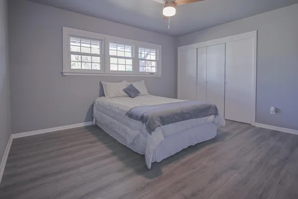 a bedroom with a bed and a window