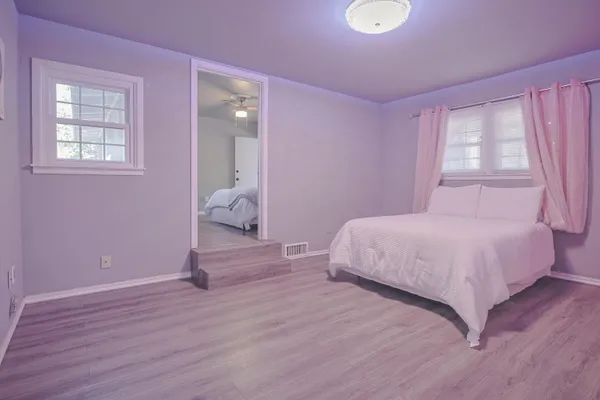 a bedroom with a bed and a lamp