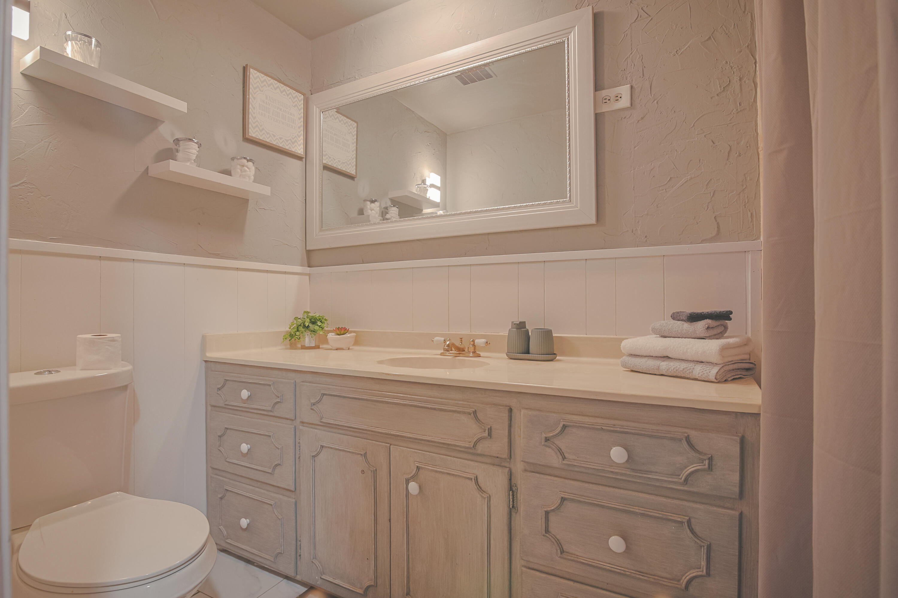 3407 Canyon Road Lubbock, TX 79403 - Photo 28 of 37 a bathroom with a toilet sink and mirror