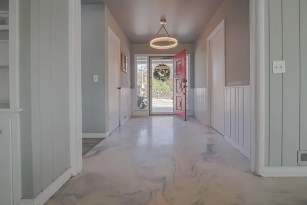 a view of a hallway with a chandelier