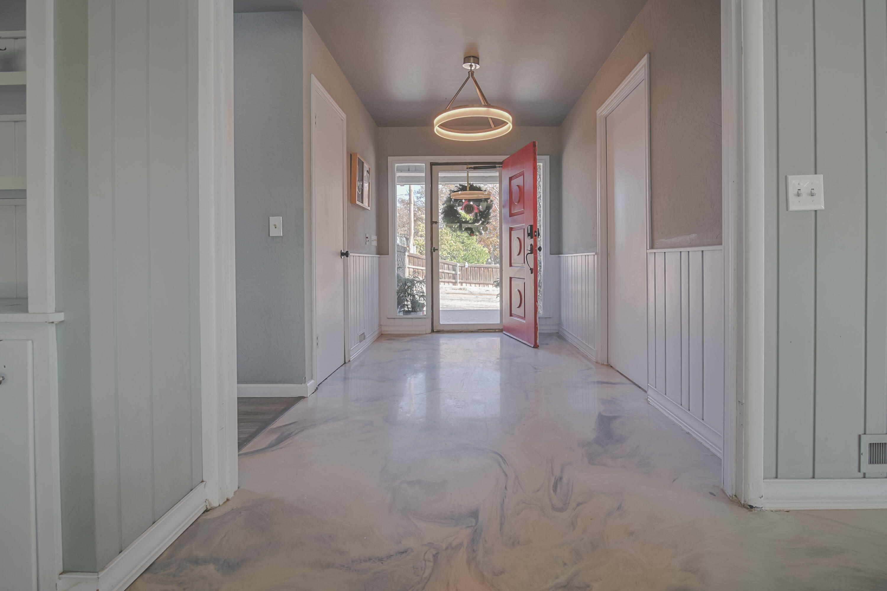 3407 Canyon Road Lubbock, TX 79403 - Photo 3 of 37 a view of a hallway with a chandelier