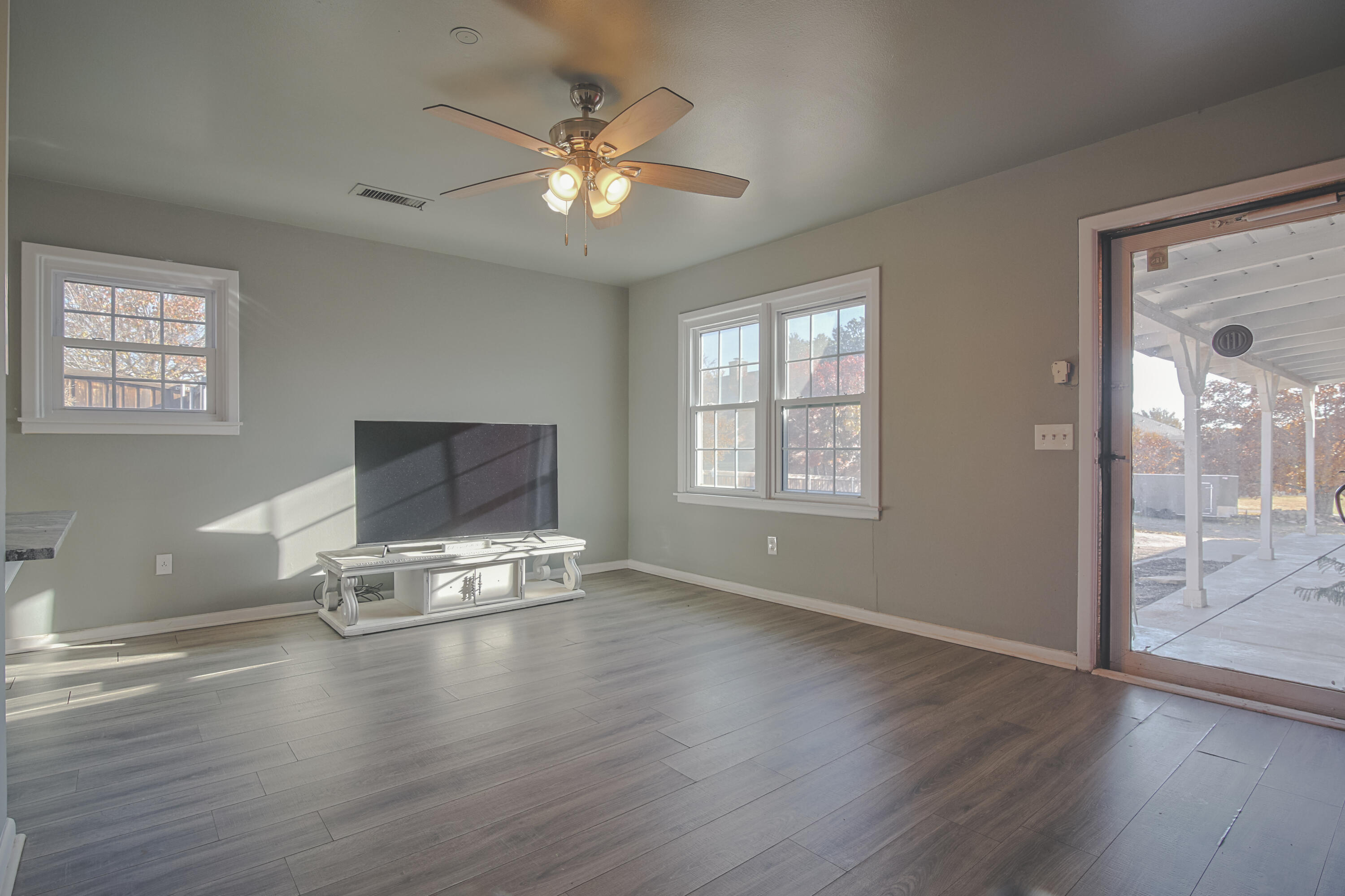 3407 Canyon Road Lubbock, TX 79403 - Photo 32 of 37 a living room with hard wood floors and a ceiling fan