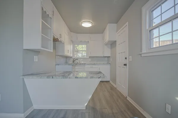 a view of balcony with wooden floor and seating space
