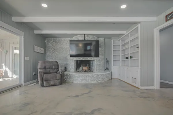 a living room with furniture and a fireplace