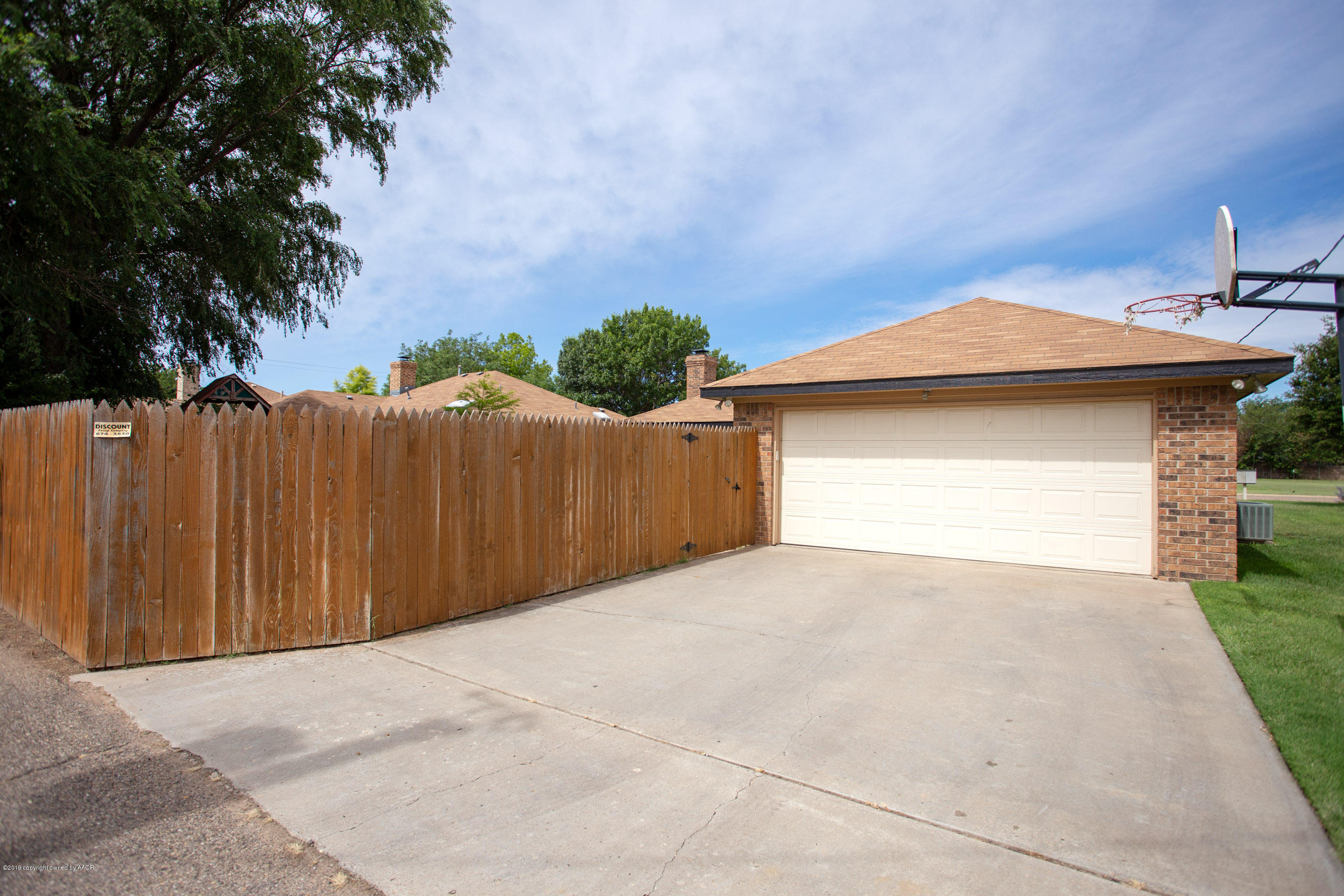 8007 Arbor Street Amarillo, TX 79110 - Photo 25 of 25 a front view of a house with a garage and a yard