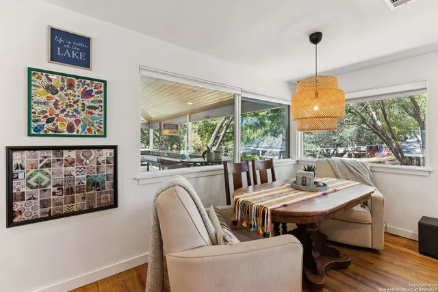 a dining room with furniture a chandelier and wooden floor