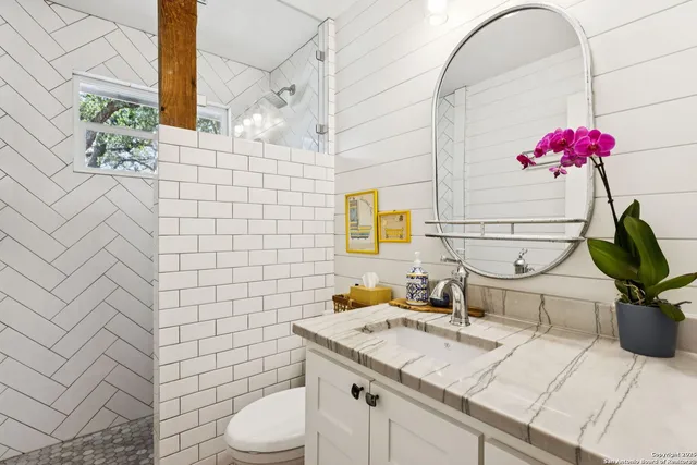 a bathroom with a sink toilet and shower