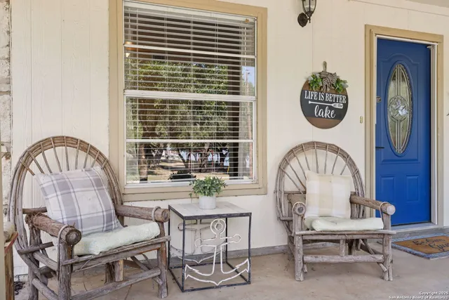 a view of a dining room with furniture and a large window