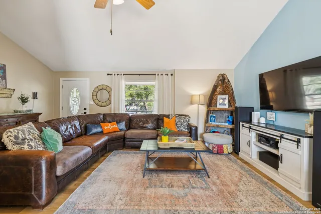 a living room with furniture and a flat screen tv