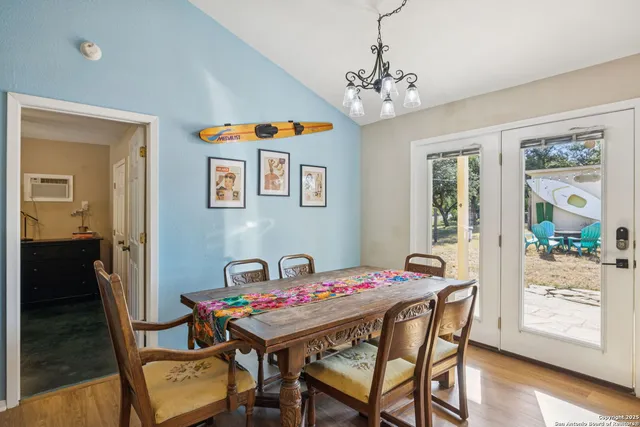 a view of a dining room with furniture wooden floor and a chandelier