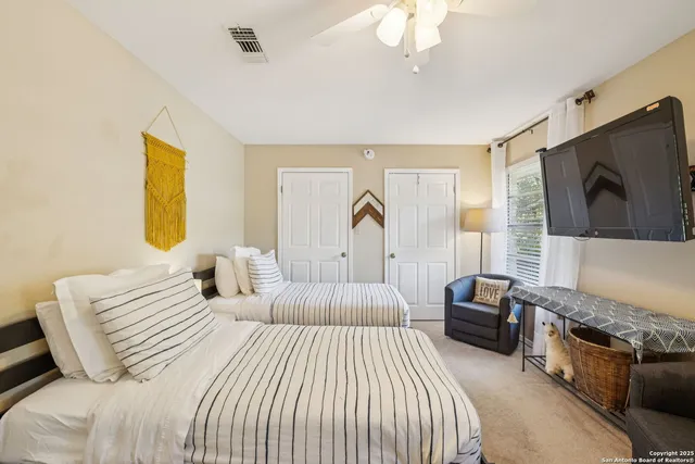 a bedroom with a bed and a flat screen tv