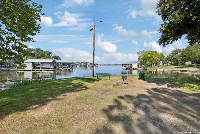 a backyard of a house with table and chairs