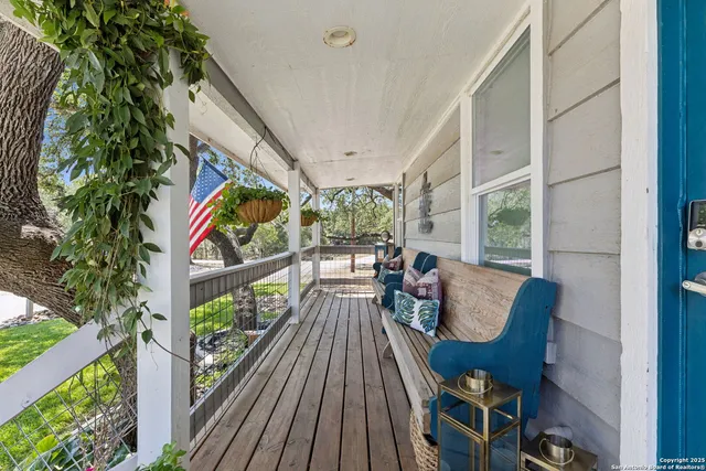 a balcony with wooden floor and furniture