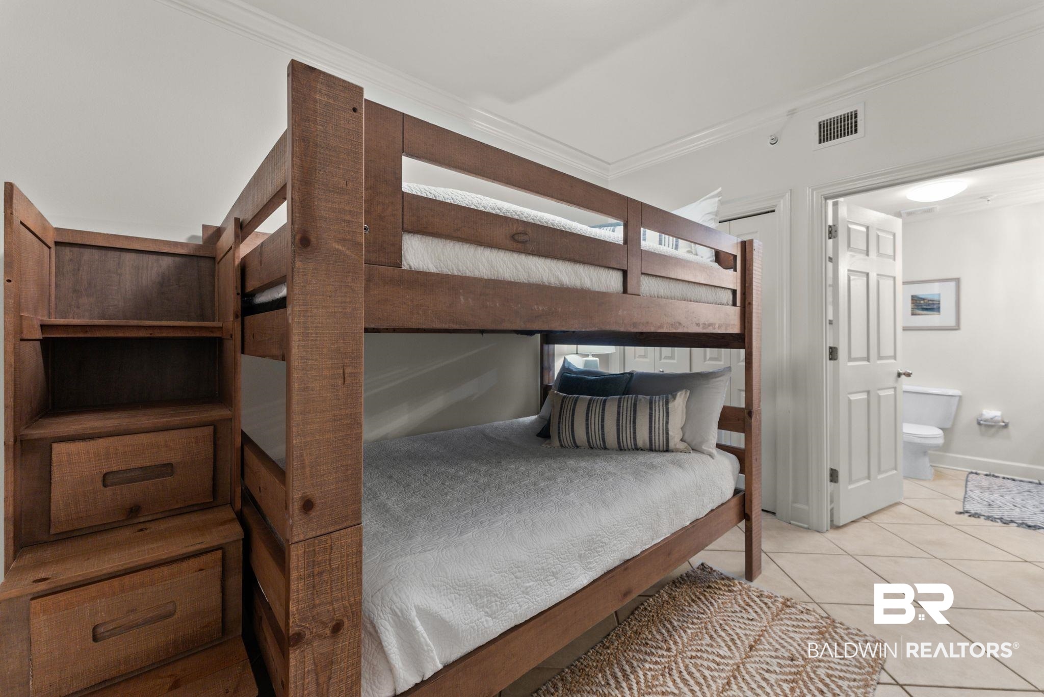 27580 Canal Road, Unit 1233 Orange Beach, AL 36561 - Photo 14 of 79 Bedroom featuring crown molding, light tile patterned floors, and ensuite bath