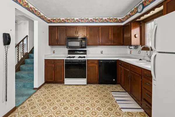 a kitchen with a refrigerator sink and cabinets
