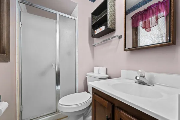 an empty room with a ceiling fan and carpet