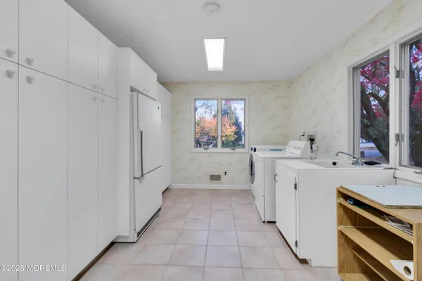 an empty room with windows and fireplace