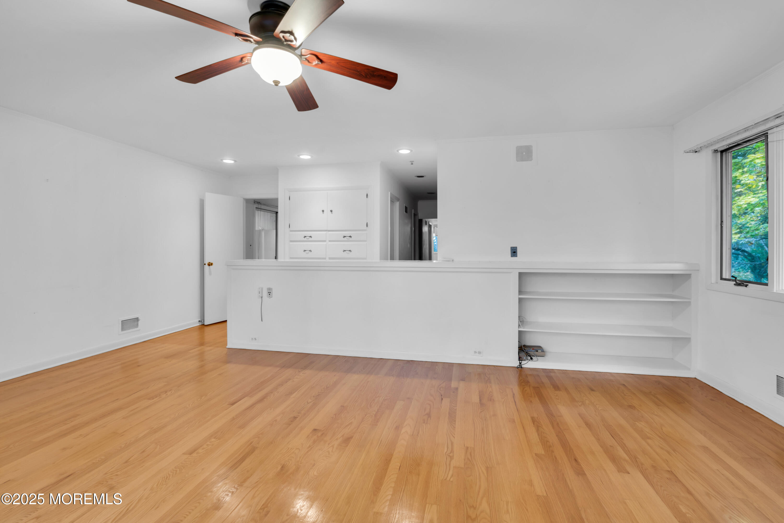642 Rankin Road Brielle, NJ 08730 - Photo 20 of 59 a view of empty room with wooden floor and fan