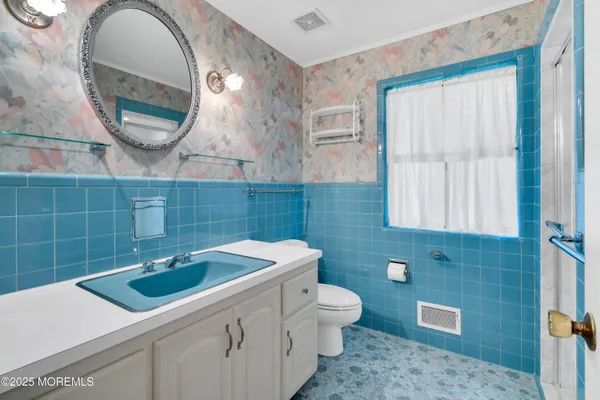 a bathroom with a glass shower door