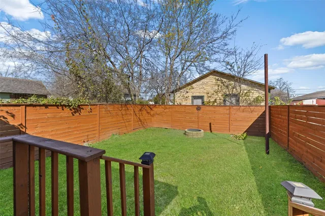a view of a yard with large trees