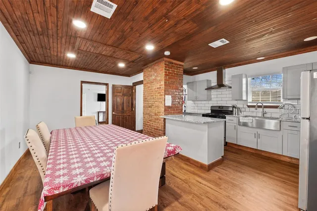 a kitchen with sink cabinets and wooden floor