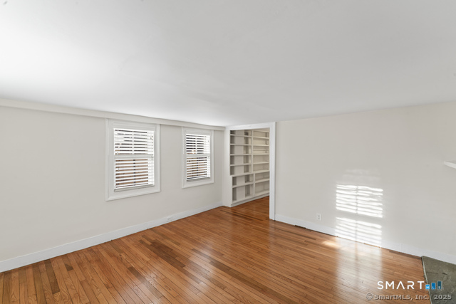 3 Riverside Road, Unit B Newtown, CT 06482 - Photo 9 of 20 a view of an empty room with wooden floor and a window