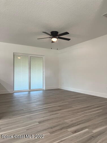 998 Cardon Drive Rockledge, FL 32955 - Photo 3 of 21 a view of an empty room with wooden floor