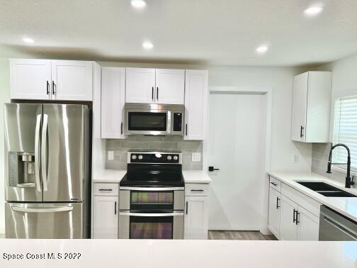 998 Cardon Drive Rockledge, FL 32955 - Photo 6 of 21 a kitchen with stainless steel appliances a refrigerator stove and microwave