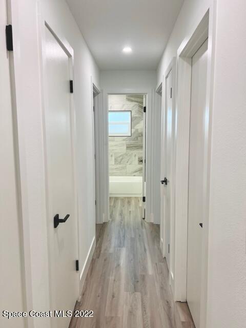 998 Cardon Drive Rockledge, FL 32955 - Photo 8 of 21 a view of a hallway with wooden floor and closet area