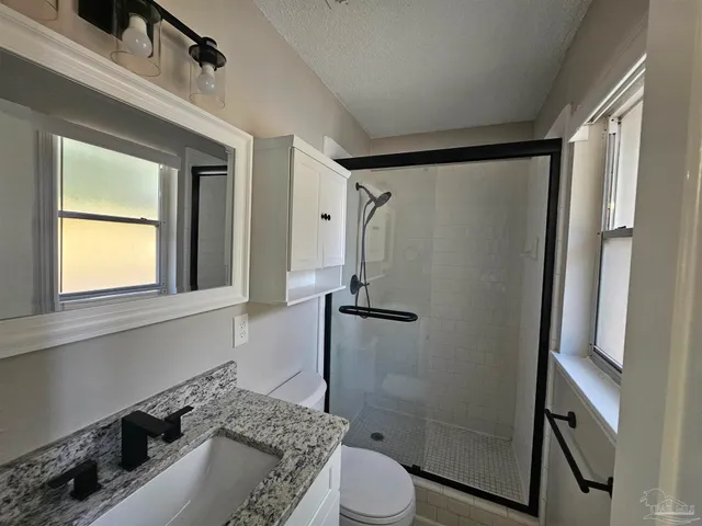a bathroom with a sink toilet and shower