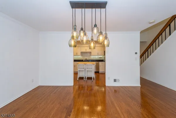 a dining room with furniture and chandelier