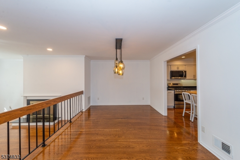 3 Avery Court Madison, NJ 07940 - Photo 16 of 50 a view of empty room with wooden floor and windows