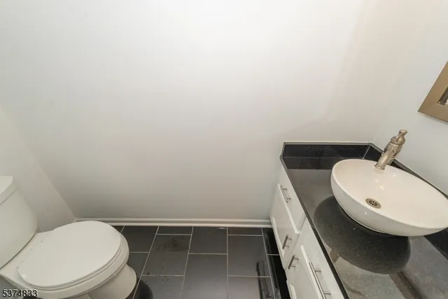 a view of empty room with wooden floor and fireplace