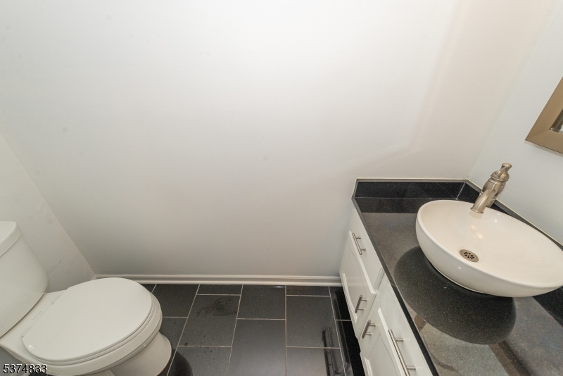 3 Avery Court Madison, NJ 07940 - Photo 18 of 50 a bathroom with a toilet a sink and mirror
