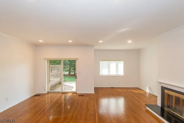 a living room with furniture flat screen tv and a large window