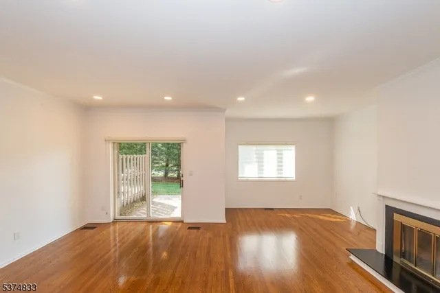 a living room with furniture flat screen tv and a large window