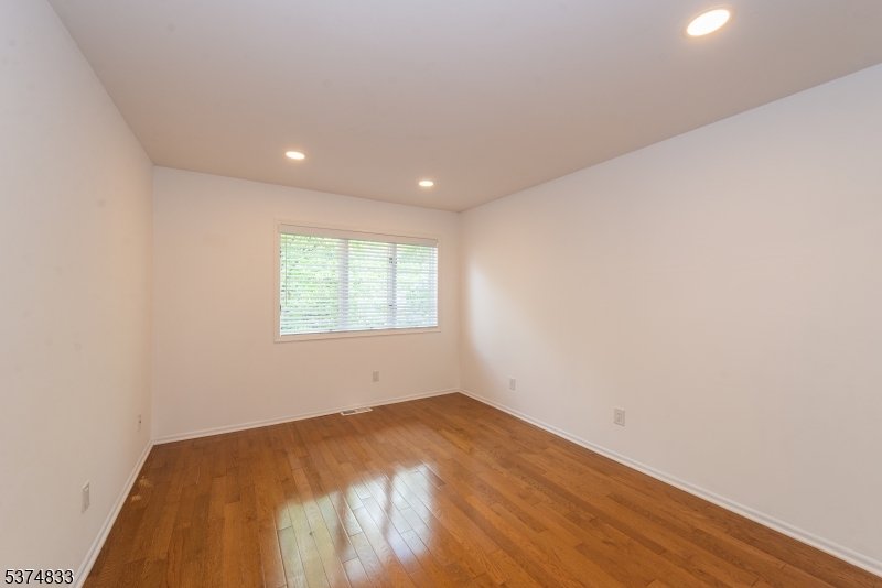 3 Avery Court Madison, NJ 07940 - Photo 28 of 50 an empty room with wooden floor and windows