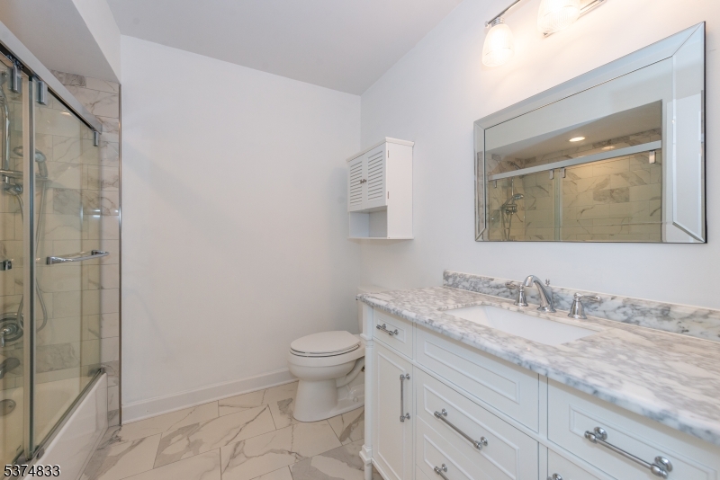 3 Avery Court Madison, NJ 07940 - Photo 33 of 50 a bathroom with a granite countertop sink a toilet and a mirror