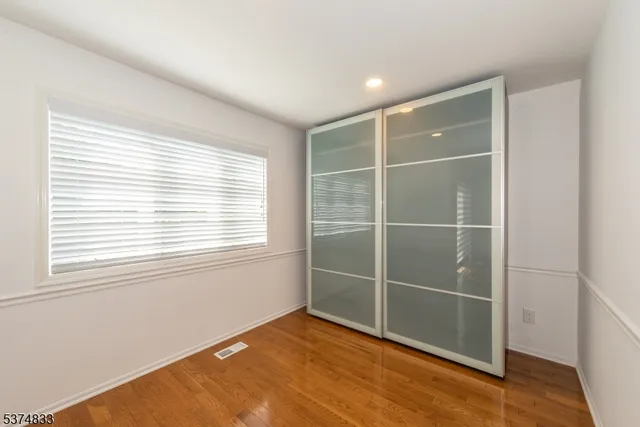 a view of a room with wooden floor